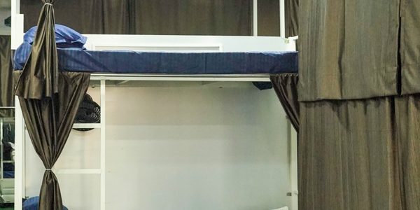 Lower bunk with lockable storage drawers and a personal fan at Zest Stays 1054