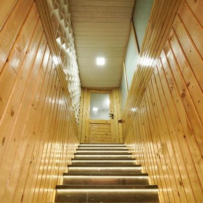 Lit wooden staircase between floors at Zest Stays 1054
